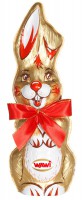 "Osterhase aus Edelvollmilch Schokolade in hochwertiger gold Staniolfolie verpackt und mit rot-goldener Satinschleife dekoriert"